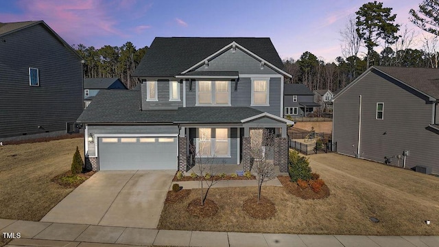 view of front facade with a lawn and a garage