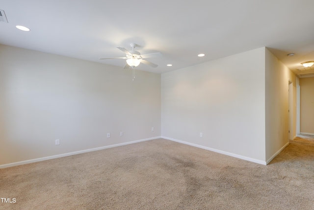 carpeted spare room with ceiling fan