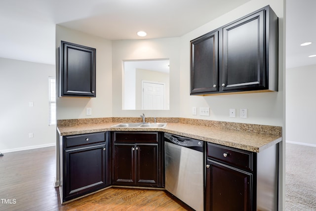 kitchen featuring stainless steel dishwasher, light hardwood / wood-style floors, and sink