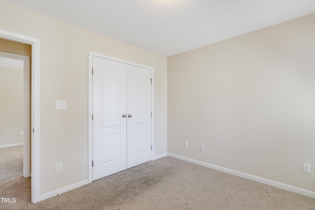 unfurnished bedroom featuring carpet and a closet