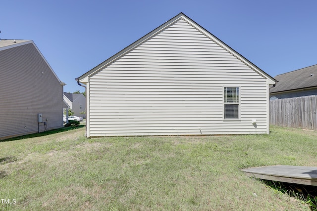 view of side of property with a yard