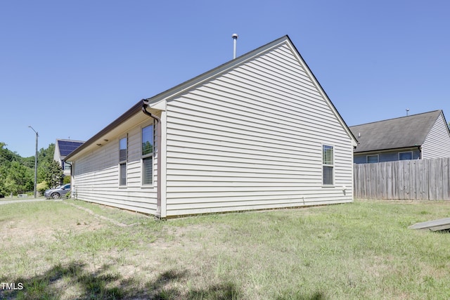 view of property exterior featuring a lawn