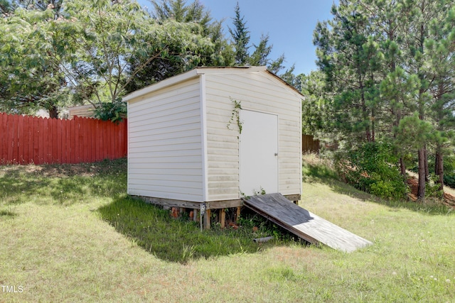 view of outbuilding featuring a lawn