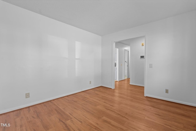 empty room with light hardwood / wood-style flooring