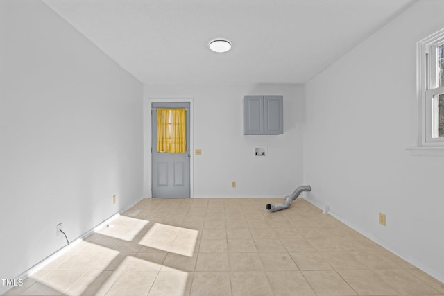 washroom with light tile patterned floors and hookup for a washing machine