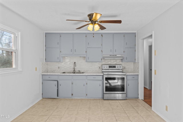 kitchen featuring gray cabinetry, stainless steel electric range oven, sink, and ceiling fan