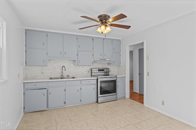 kitchen with electric stove, sink, ceiling fan, gray cabinets, and light tile patterned floors