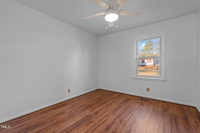 spare room with ceiling fan and dark hardwood / wood-style flooring