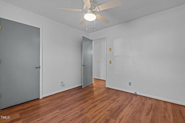 spare room with ceiling fan and wood-type flooring