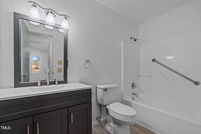 full bathroom featuring bathing tub / shower combination, hardwood / wood-style floors, vanity, and toilet