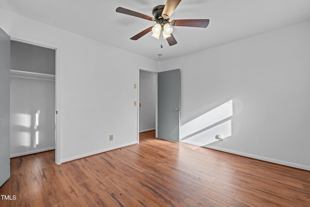 unfurnished bedroom with wood-type flooring, a closet, and ceiling fan