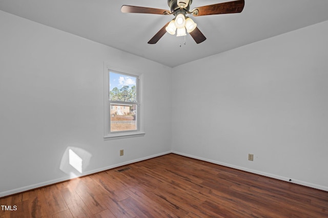 empty room with ceiling fan and dark hardwood / wood-style floors