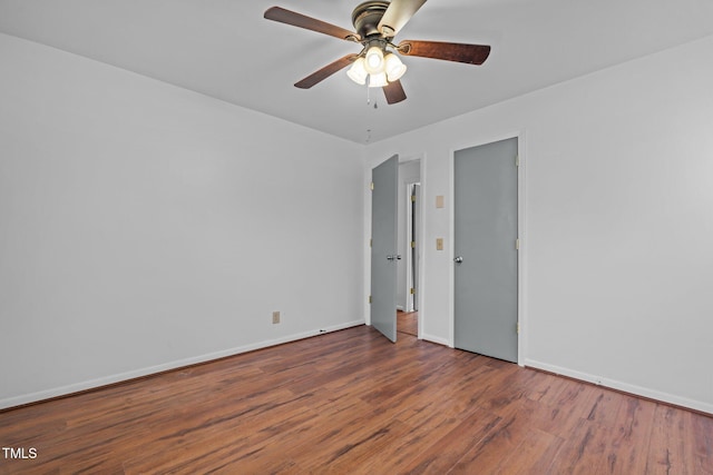 empty room with ceiling fan and hardwood / wood-style flooring