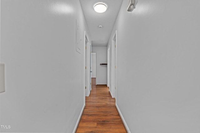 hallway featuring a textured ceiling and dark wood-type flooring