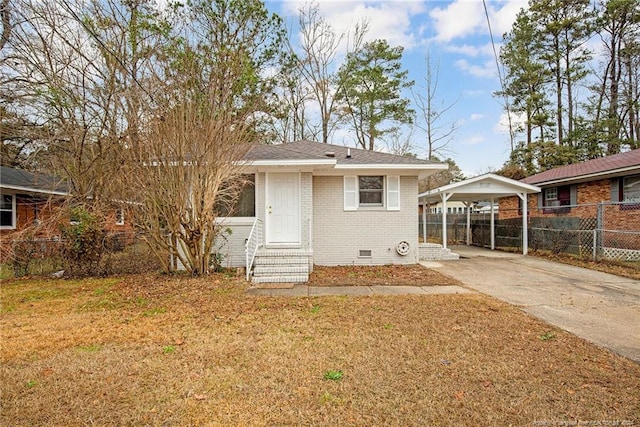 rear view of house featuring a carport and a lawn