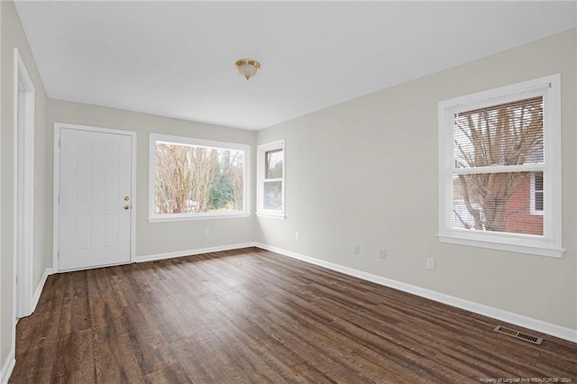 unfurnished room with dark hardwood / wood-style flooring