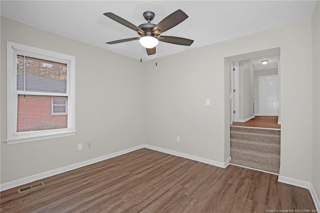 unfurnished room featuring dark hardwood / wood-style floors and ceiling fan