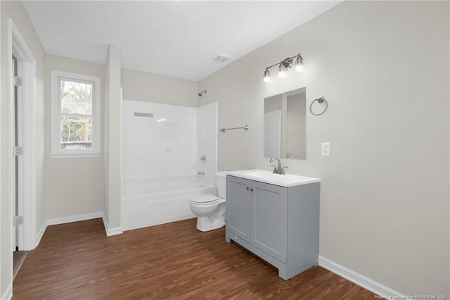 full bathroom with hardwood / wood-style floors, vanity, toilet, and bathtub / shower combination