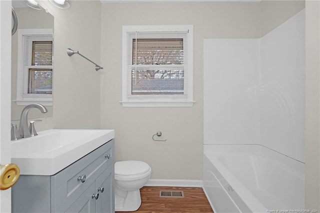 full bathroom featuring shower / tub combination, hardwood / wood-style floors, vanity, and toilet