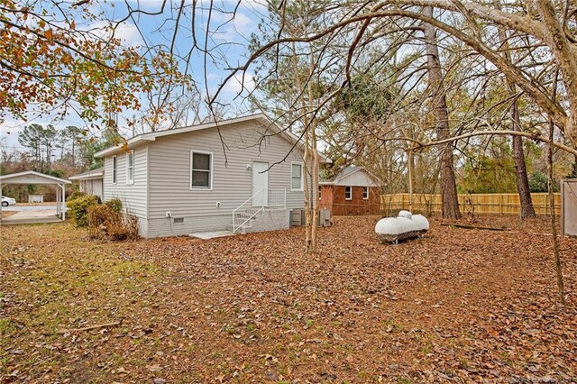 view of home's exterior with a carport and cooling unit