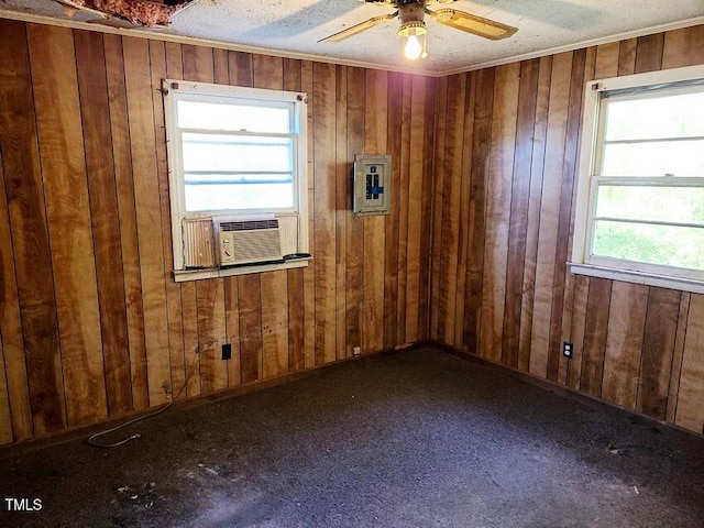 empty room with electric panel, ceiling fan, cooling unit, and a textured ceiling