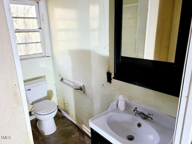 bathroom with tile patterned flooring, vanity, and toilet