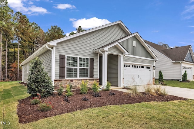 craftsman inspired home featuring a garage and a front lawn