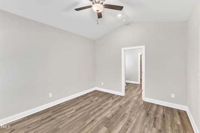 empty room featuring ceiling fan, lofted ceiling, and light wood-type flooring