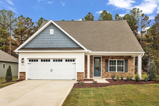 craftsman-style house with a garage and a front lawn