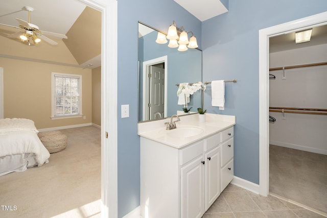 bathroom featuring tile patterned floors, ceiling fan, vanity, and lofted ceiling