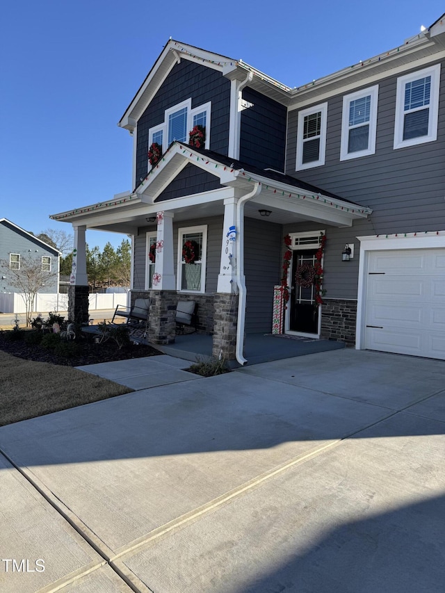 view of front facade with a porch and a garage