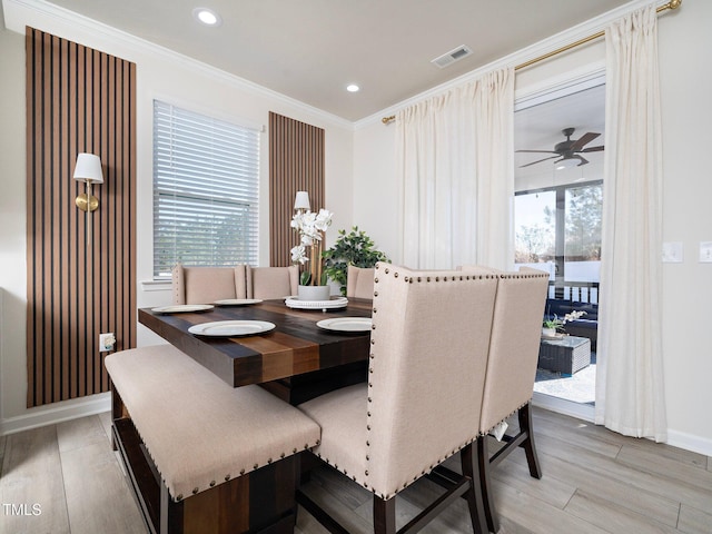 dining area with ceiling fan, hardwood / wood-style floors, and ornamental molding