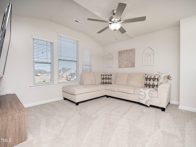 carpeted living room with ceiling fan and lofted ceiling