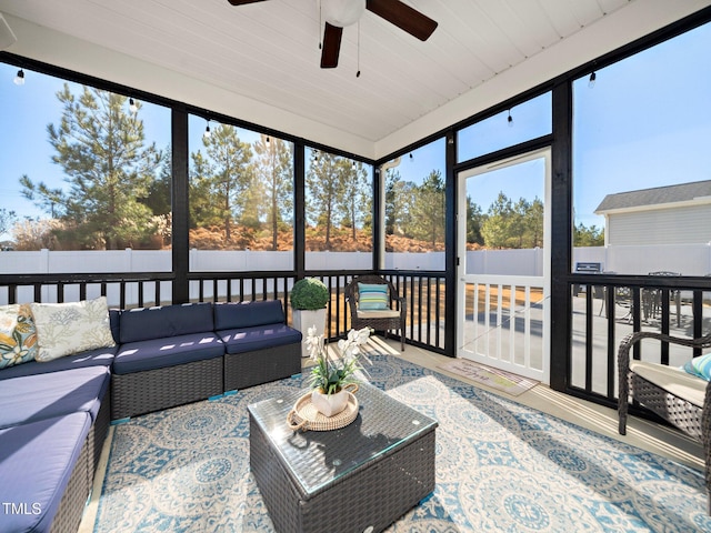 sunroom featuring ceiling fan and plenty of natural light