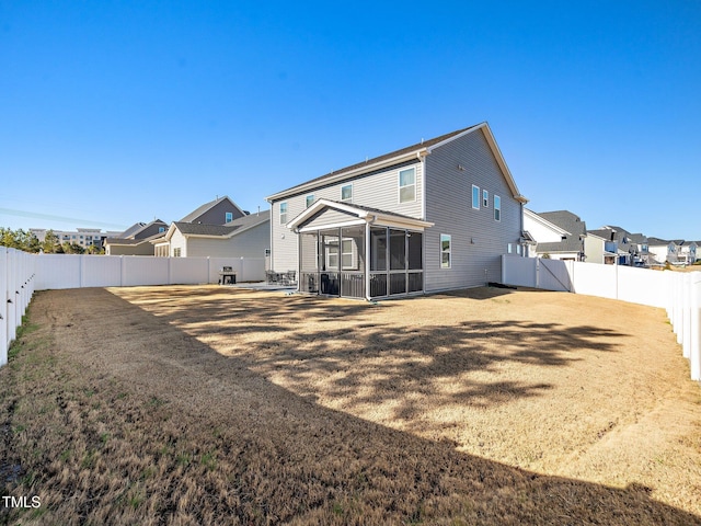 rear view of house featuring a sunroom