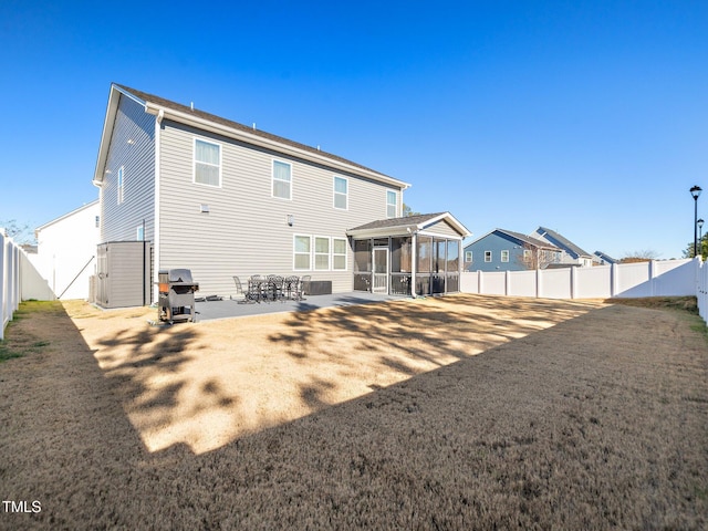 rear view of property featuring a sunroom and a patio