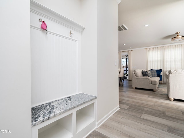 mudroom featuring ornamental molding and light hardwood / wood-style flooring