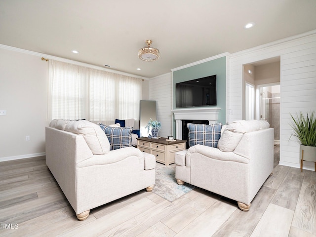 living room with light wood-type flooring and ornamental molding