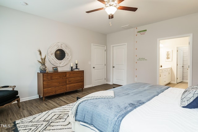 bedroom featuring ceiling fan, dark hardwood / wood-style floors, and ensuite bath