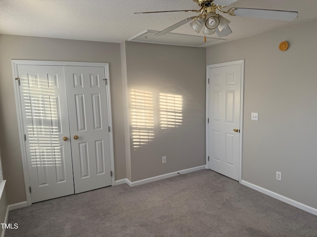 empty room with a textured ceiling, light colored carpet, and ceiling fan