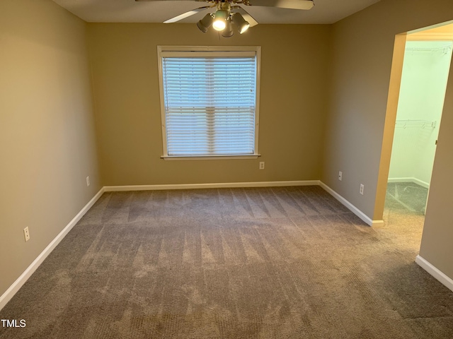 carpeted empty room featuring ceiling fan