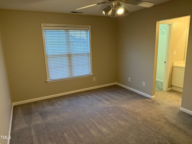 carpeted empty room with ceiling fan