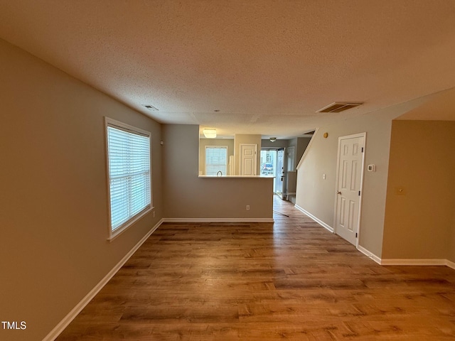 spare room with wood-type flooring and a textured ceiling