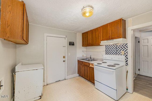 kitchen featuring white range with electric stovetop, refrigerator, a textured ceiling, and extractor fan