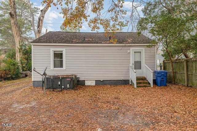 rear view of property with central AC unit