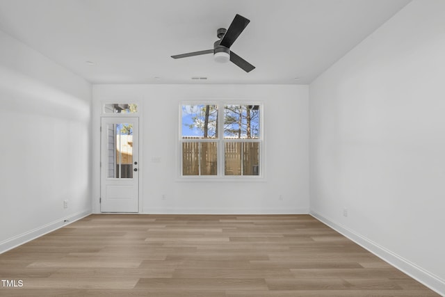 spare room with ceiling fan and light wood-type flooring