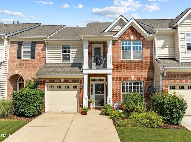 multi unit property featuring a balcony and a garage