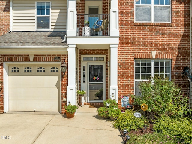 doorway to property featuring a garage and a balcony