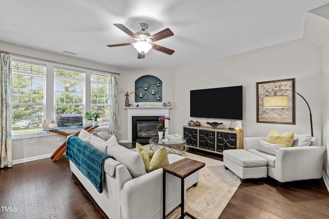 living room with ceiling fan and dark wood-type flooring