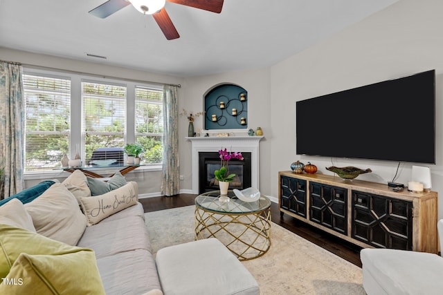 living room with dark hardwood / wood-style floors and ceiling fan